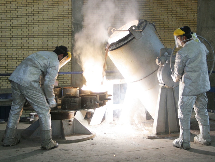 caption: Technicians work inside of a uranium conversion facility producing unit in 2005 outside the city of Isfahan, Iran. After the 2015 Iran nuclear deal put limits on the program, Iran's government has been increasing uranium enrichment since the United States pulled out of deal.