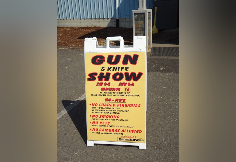 caption: A welcome sign greets customers outside the Wes Knodel Gun and Knife Show.