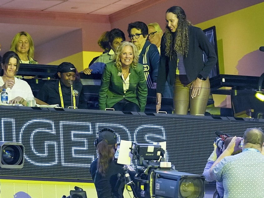 caption: First Lady Jill Biden takes a her seat before the start of the NCAA Women's Final Four championship basketball game between LSU and Iowa Sunday, April 2, 2023, in Dallas.
