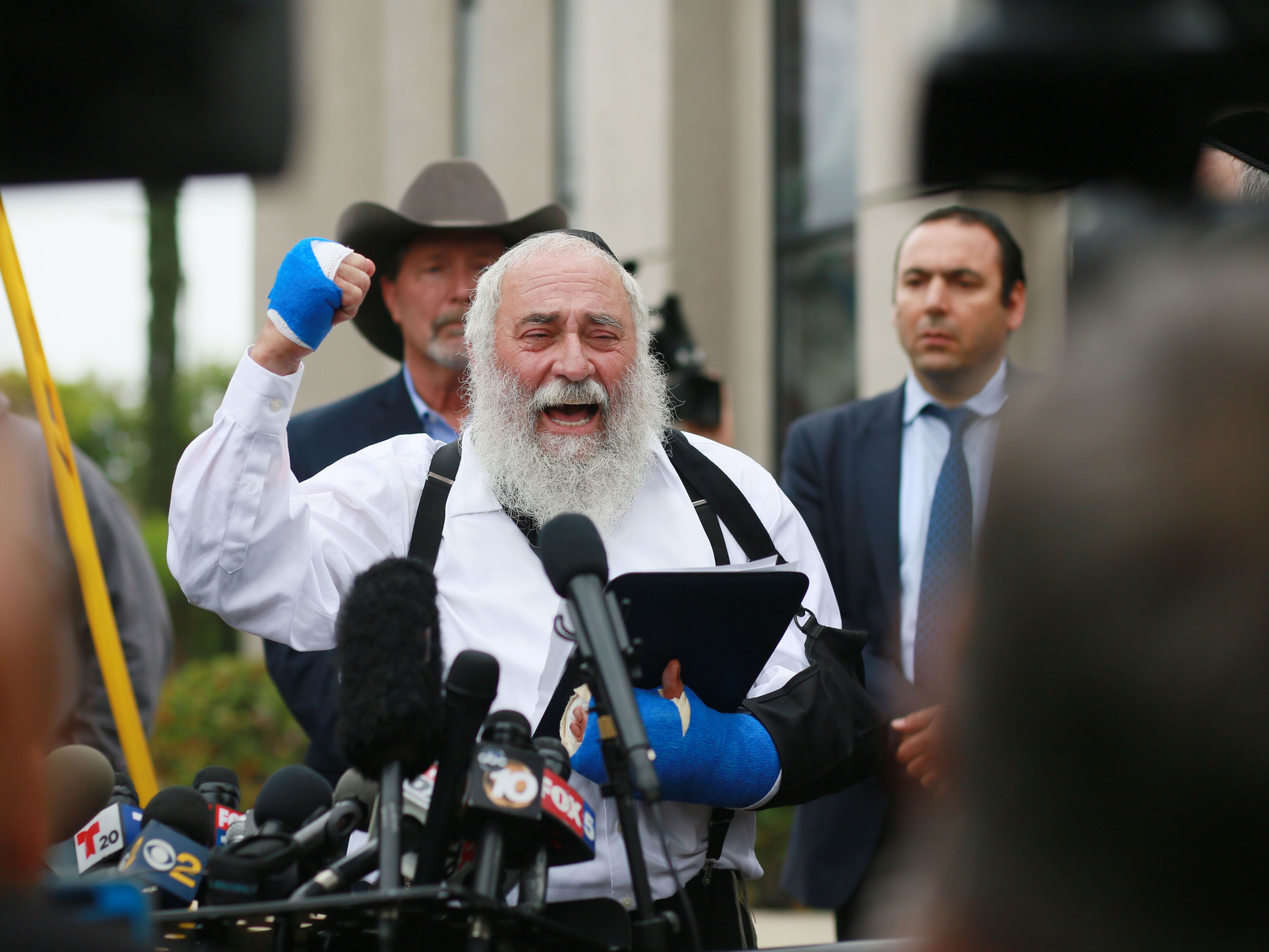 caption: A day after his synagogue was attacked, Rabbi Yisroel Goldstein held a press conference outside the Chabad of Poway Synagogue to recount what happened during the deadly attack.