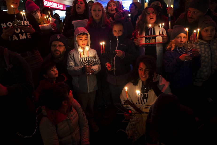 caption: A large crowd led by Jewish Voice for Peace - Seattle gathered to light candles on the second night of Hanukkah, or Chanukah, and call for an immediate ceasefire in Gaza on Friday, December 8, 2023, at Pike Place Market in Seattle.