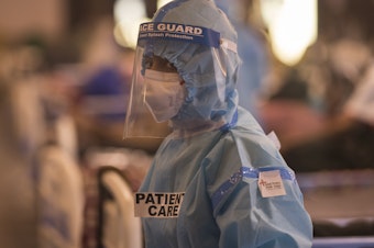 caption: A medical worker is seen at a quarantine center for Covid-19 coronavirus infected patients at a banquet hall, which was converted into an isolation center to handle the rising cases of infection in New Delhi, India.
