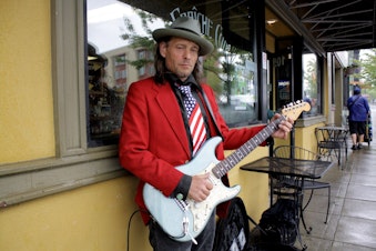 caption: Kenny Wayne Gunner plays guitar in downtown Bremerton at lunch time