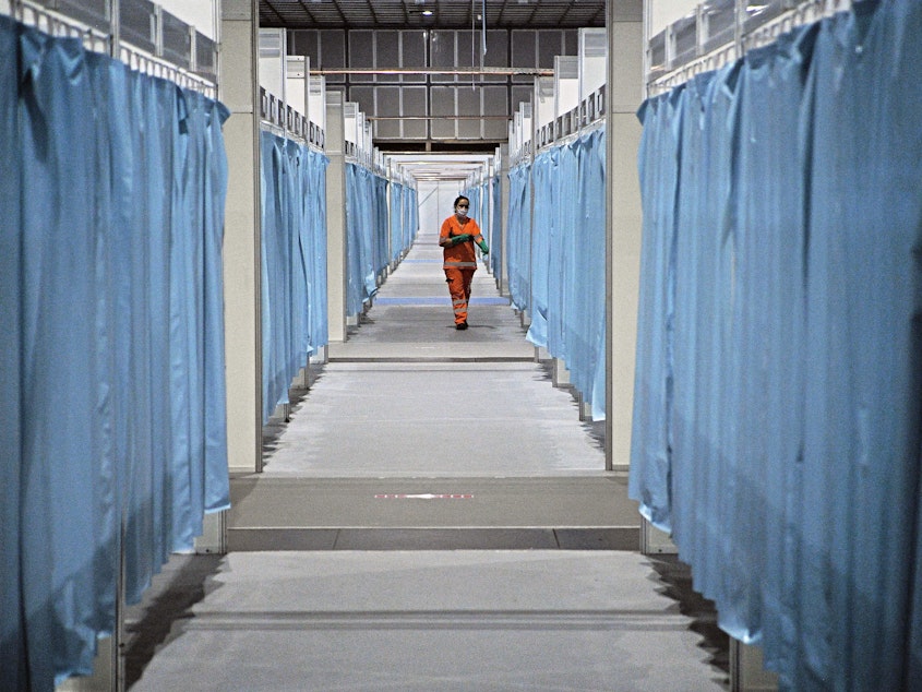 caption: A custodian walk down the corridor of a field hospital set up for COVID-19 patients in Rio de Janeiro. Brazil has emerged as a new hot spot of the coronavirus, which in a span of just three months has reached virtually every country in the world.