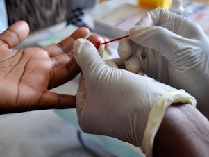 Drawing blood to test for HIV.