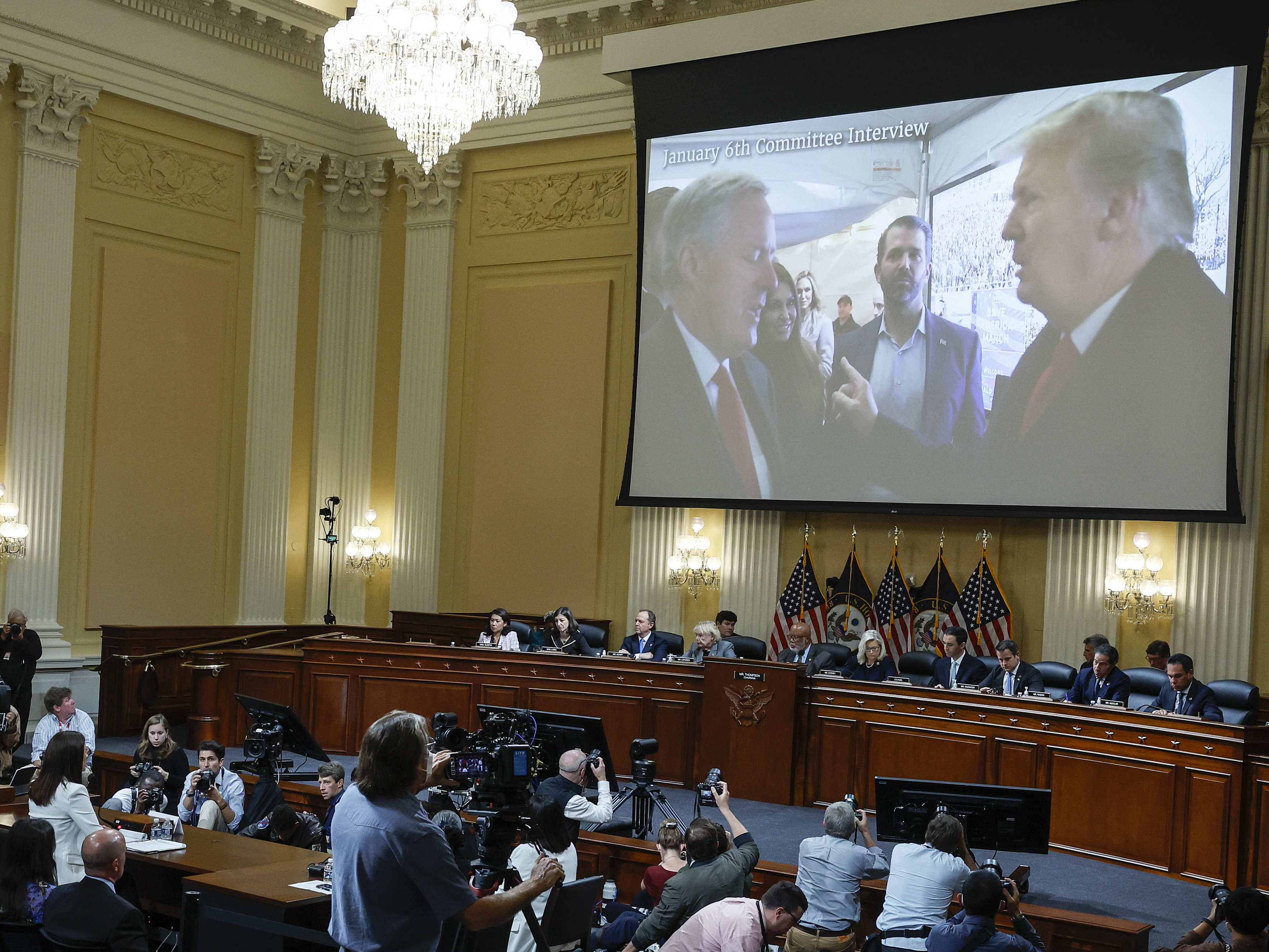 caption: An image of former President Donald Trump talking to his Chief of Staff Mark Meadows is displayed as Cassidy Hutchinson, a former top aide to Meadows, testifies about events around the Capitol insurrection to the House Jan. 6 select committee.