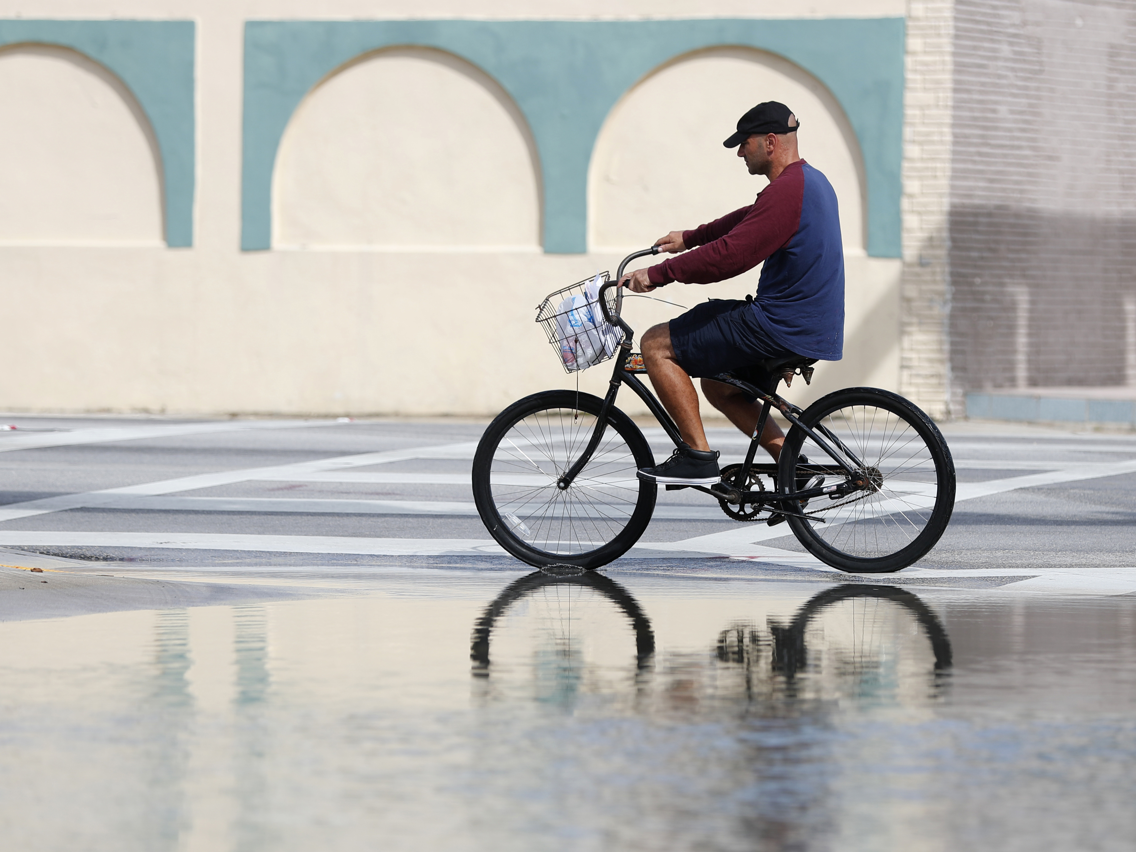 caption: A street in Miami flooded during a high tide in 2018. A new report confirms that the number of days with high-tide flooding is increasing in many U.S. cities as sea levels rise.