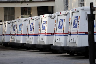 caption: United States Postal Service trucks are lined up in Miami Beach, Fla. The agency says without emergency funding from Congress, it could run out of money within months.