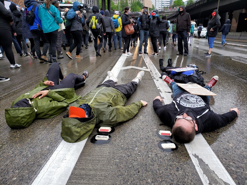 caption: Activists laid down on I-5 and chanted, "I can't breathe" in honor of George Floyd on Saturday, May 30th, 2020.