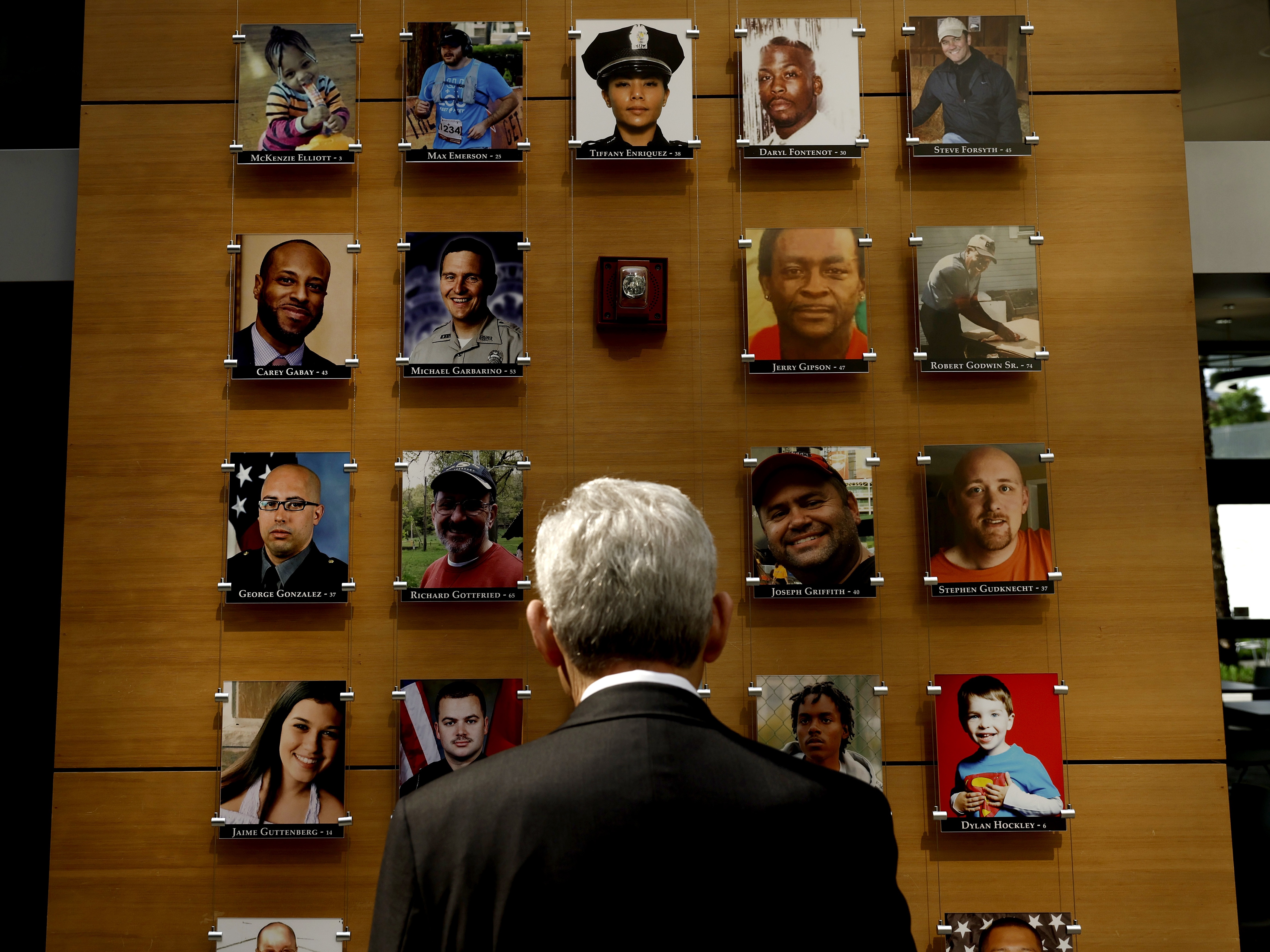 caption: Attorney General Merrick Garland looks at an exhibit titled the Faces of Gun Violence while on a tour led by Steve Dettelbach, director of the Bureau of Alcohol, Tobacco, Firearms and Explosives, at ATF headquarters on April 23, 2024, in Washington, D.C. The display has now been taken down.