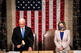 caption: Then-Vice President Mike Pence and House Speaker Nancy Pelosi preside over a joint session of Congress on Jan. 6 to certify the 2020 Electoral College results after a pro-Trump mob stormed the Capitol earlier that day.