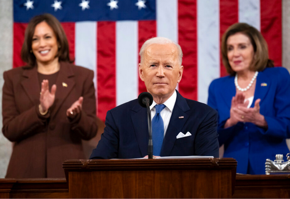 caption: President Joe Biden delivers his first State of the Union address to a joint session of Congress at the Capitol, as Vice President Kamala Harris and House Speaker Nancy Pelosi of Calif., watch, Tuesday, March 1, 2022, in Washington. 