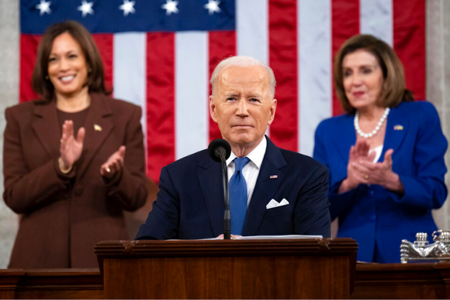 caption: President Joe Biden delivers his first State of the Union address to a joint session of Congress at the Capitol, as Vice President Kamala Harris and House Speaker Nancy Pelosi of Calif., watch, Tuesday, March 1, 2022, in Washington. 