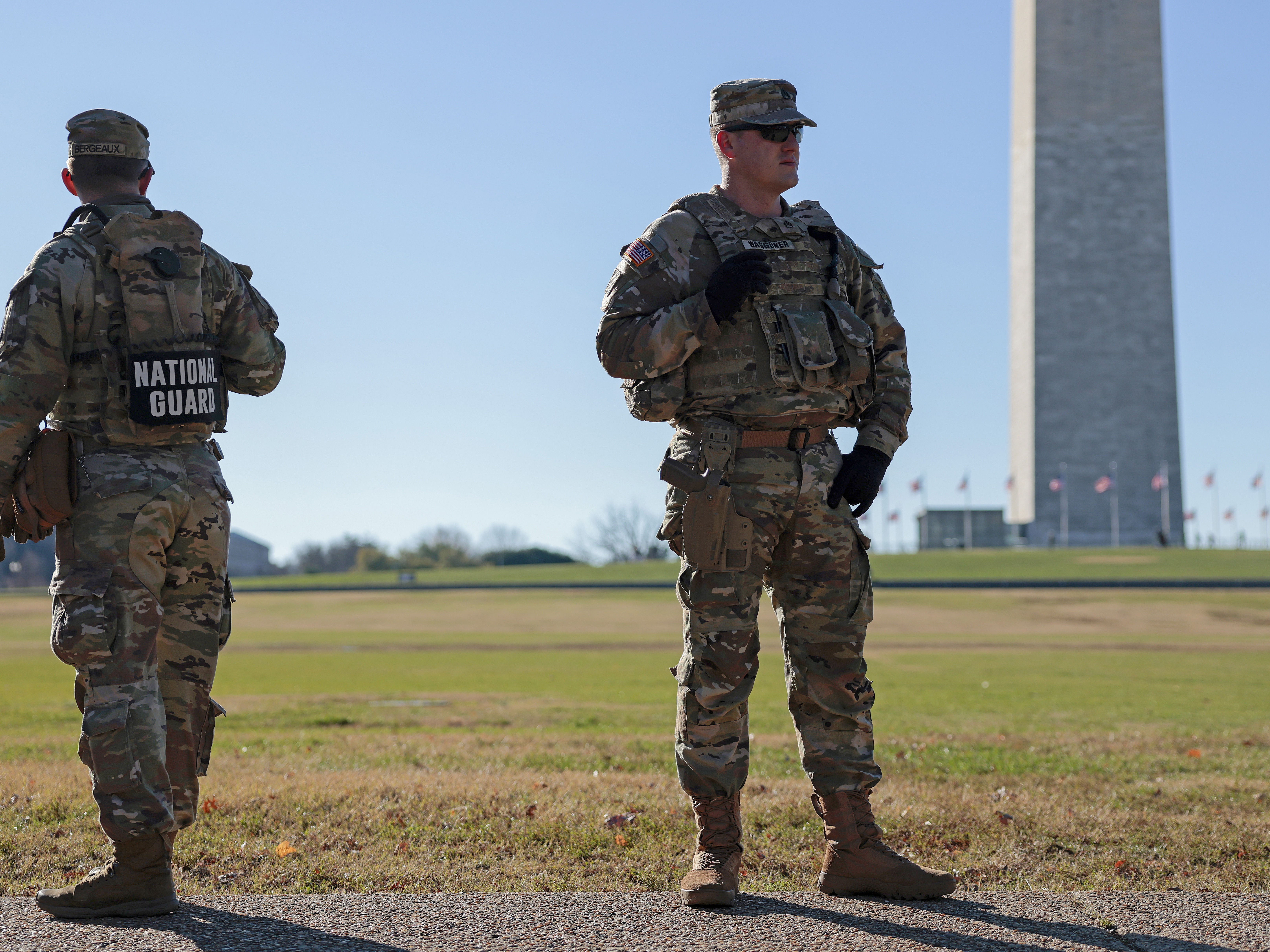 caption: Members of the National Guard patrol along Constitution Ave. on December 01, 2025 in Washington, DC.