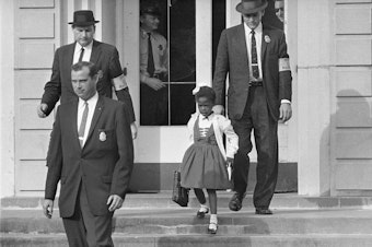 caption: U.S. Deputy Marshals escort 6-year-old Ruby Bridges from William Frantz Elementary School in New Orleans, in this November 1960, file photo. Lucille Bridges, Ruby's mother, died Tuesday at the age of 86.