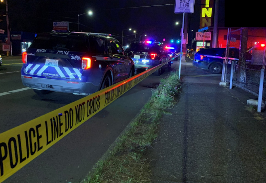 caption: Seattle police respond to a shooting at an encampment near North 96th Street and Aurora Avenue North,  Sunday evening, July 17, 2022. 