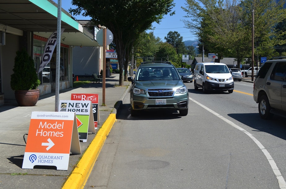 caption: Home sales signs in North Bend, Washington, due east of Seattle. The tiny town is experiencing a population boom, which is tapping its water resources.