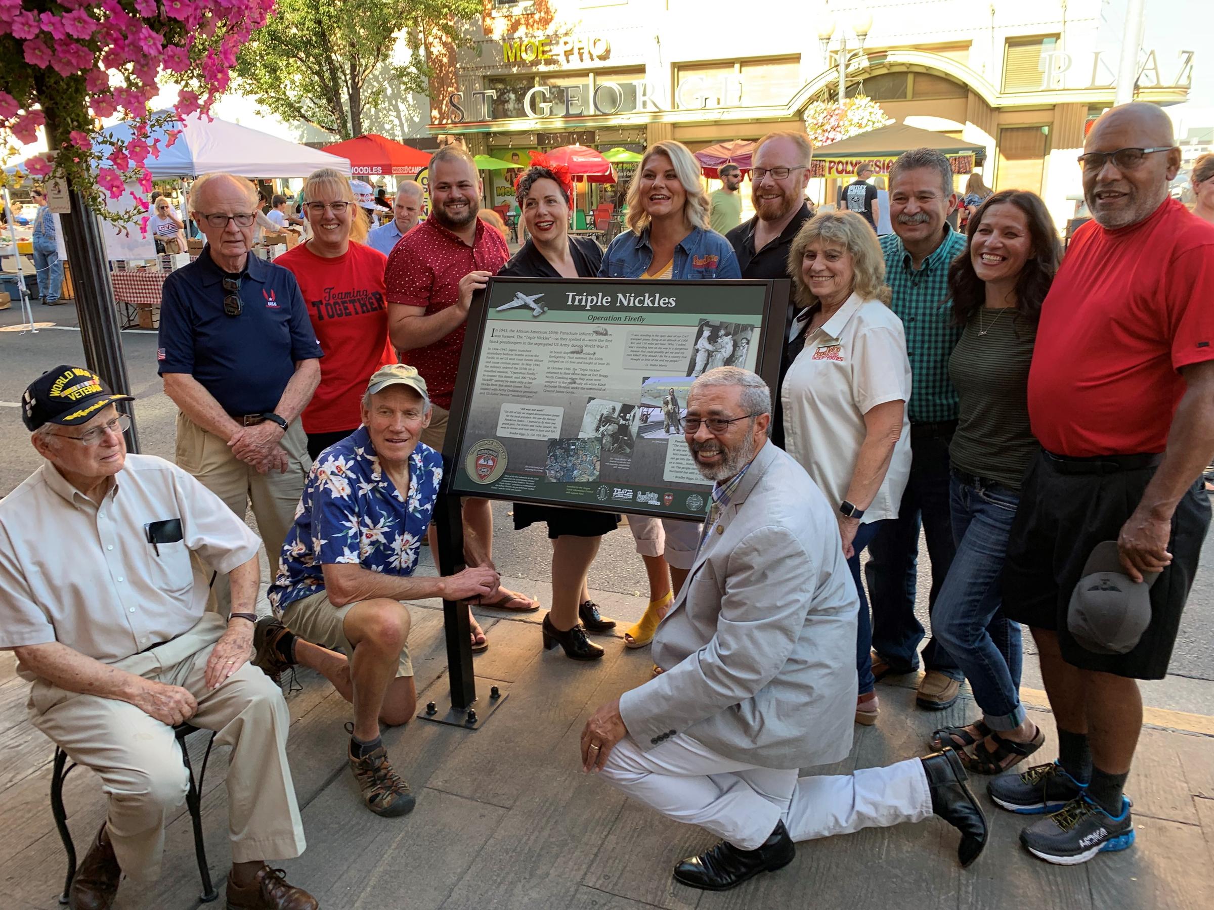 caption: Eastern Washington University senior lecturer Bob Bartlett, kneeling lower right, poses alongside other history buffs beside the new historical marker for the Triple Nickles in Pendleton on Aug. 30.
