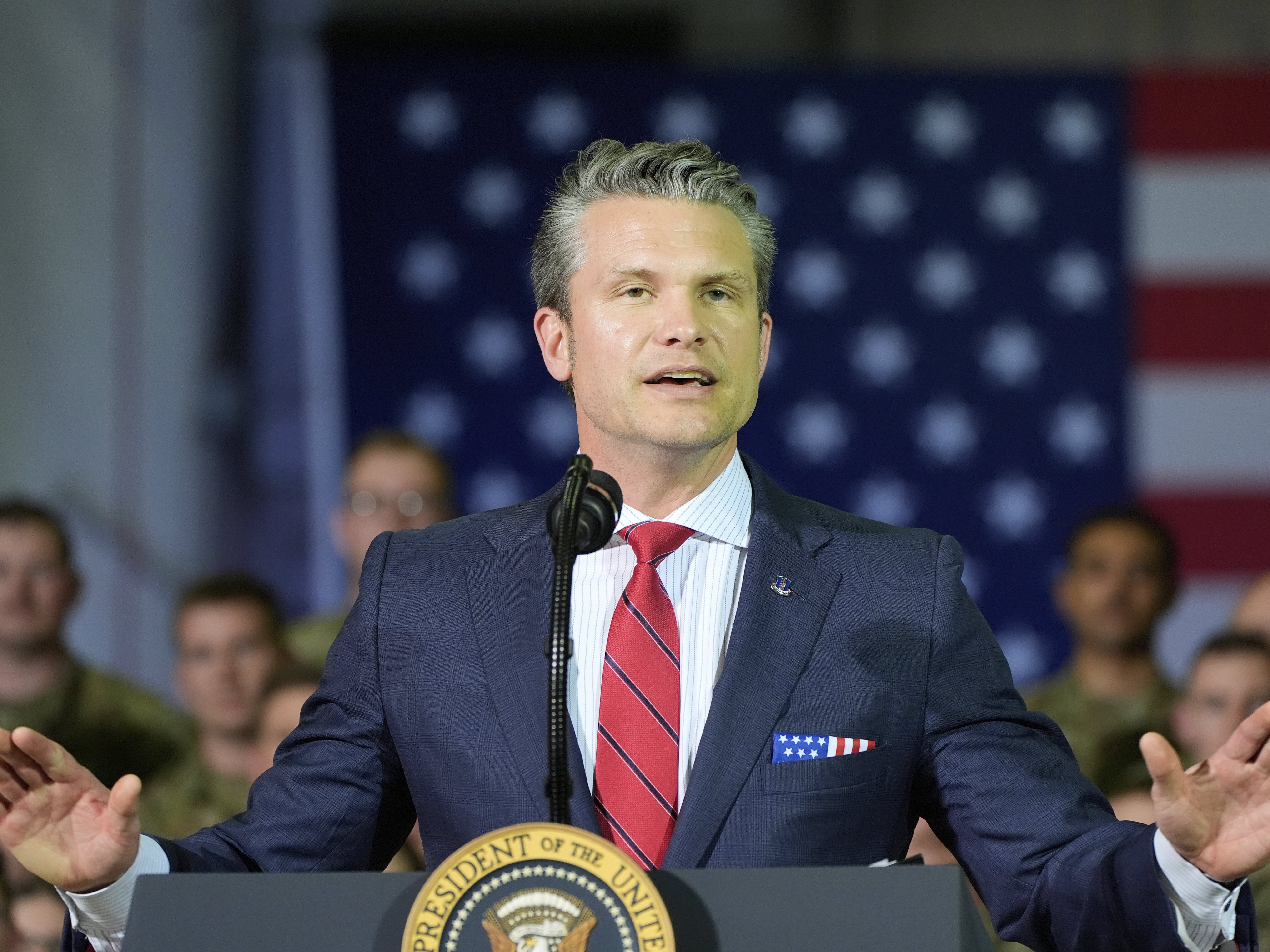 caption: Defense Secretary Pete Hegseth speaks to members of the Michigan National Guard at Selfridge Air National Guard Base, Tuesday, April 29 in Harrison Township, Mich., during a visit with President Donald Trump.