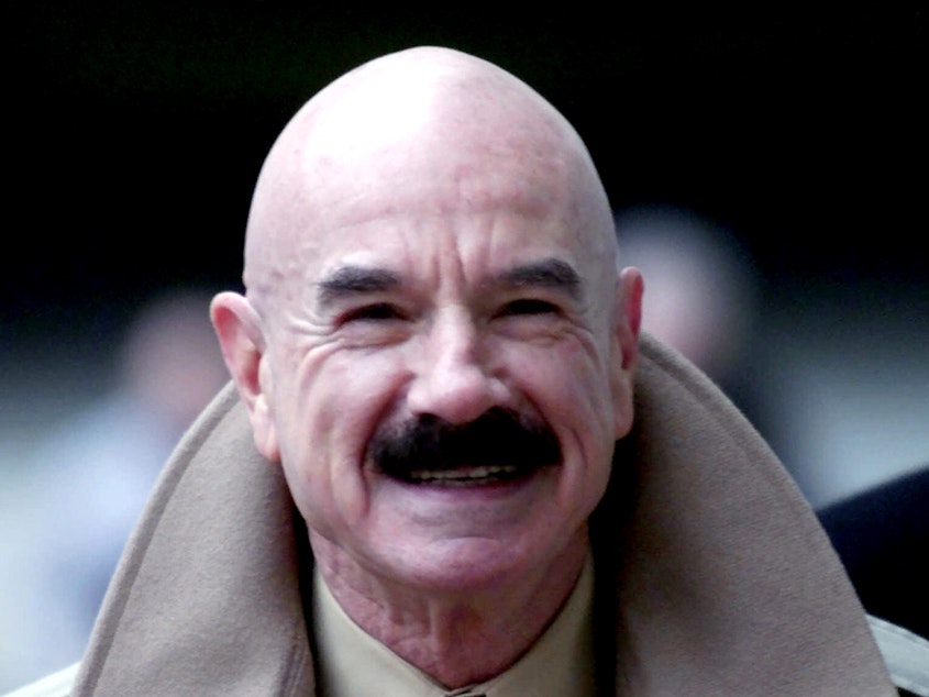 caption: G. Gordon Liddy, pictured in 2001, died on Tuesday at the age of 90. He was convicted for orchestrating the Watergate burglary and wiretapping scheme that led to President Nixon's disgraced resignation.