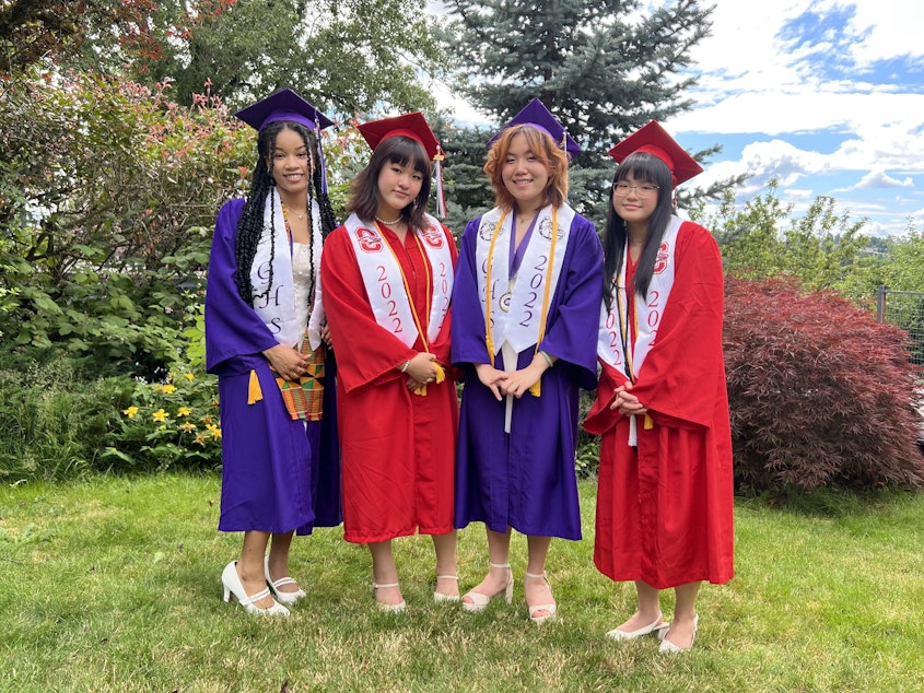 caption: Alayna Ly (fourth from left) and her three friends pose for a photo in their high school graduation caps and gowns.