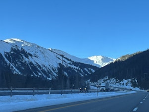 caption: Tens of thousands of vehicles pass through the Colorado Rockies a day on busy thoroughfares like Interstate 70.