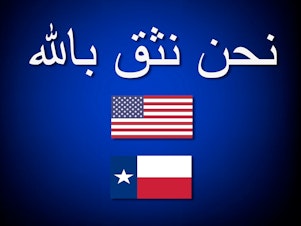 caption: A prototype of the "In God We Trust" poster written in Arabic created by Chaz Stevens.