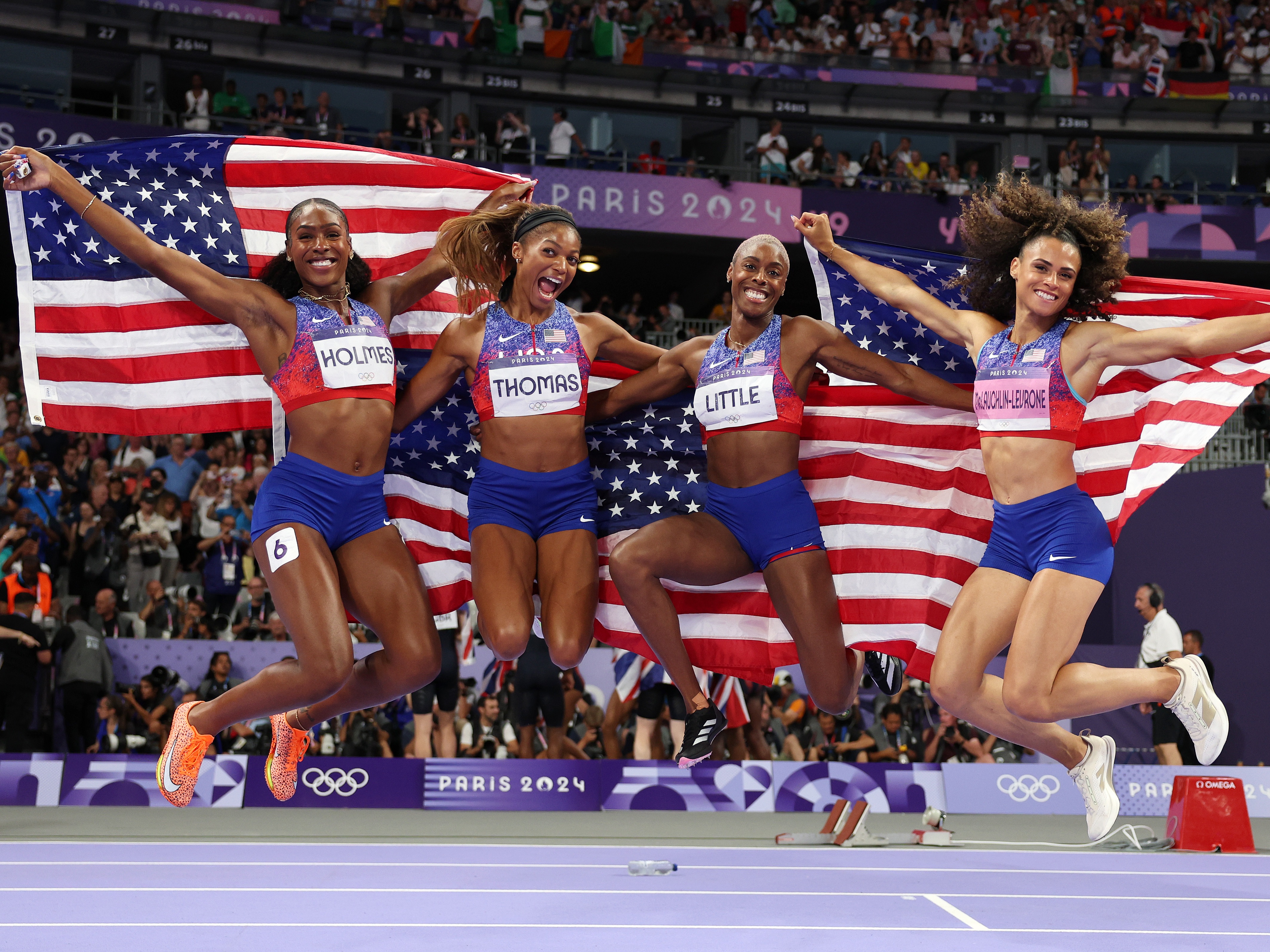 caption: Alexis Holmes, Gabby Thomas, Shamier Little and Sydney McLaughlin-Levrone (L-R) of Team USA celebrate winning the Gold medal in the Women's 4 x 400m Relay Final on Saturday at the Stade de France.