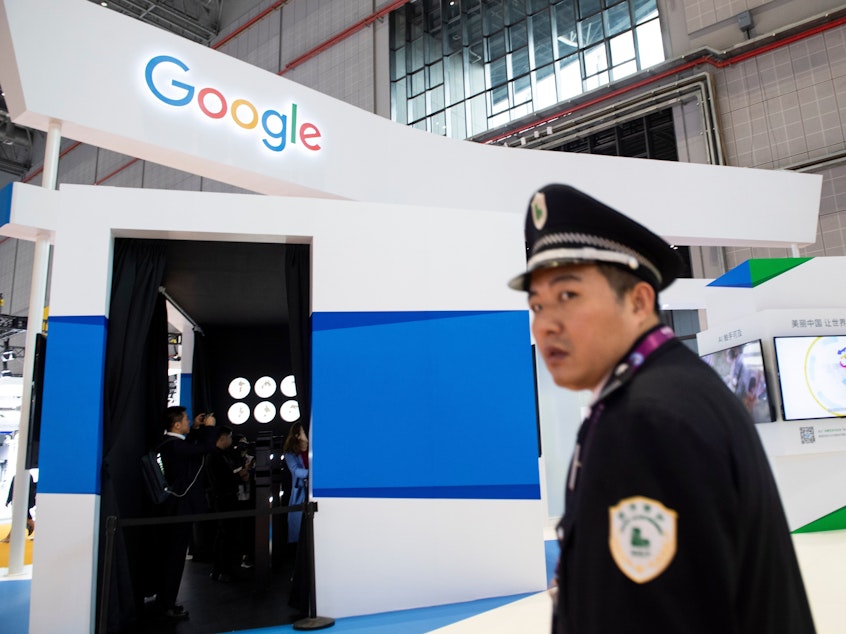 caption: A security guard stands in front of Google's booth at the China International Import Expo earlier this month in Shanghai.