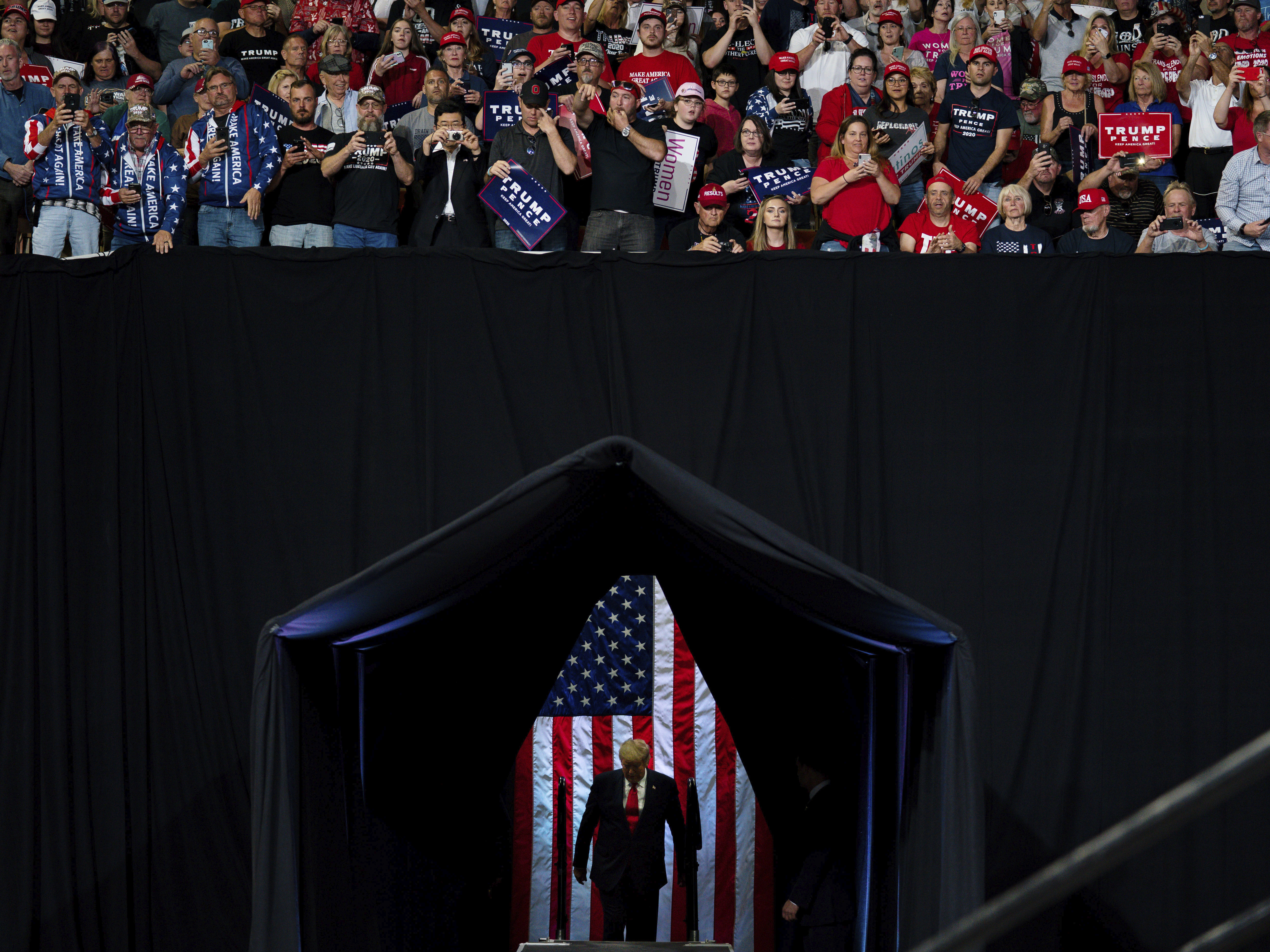 caption: President Trump arrives to speak at a campaign rally at Veterans Memorial Coliseum on Feb. 19 in Phoenix.