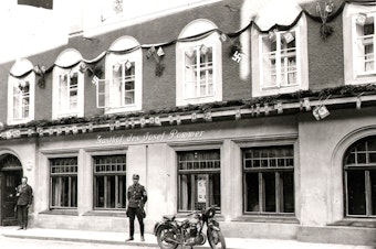caption: An archival image of the building in Braunau am Inn, Austria, where Adolf Hitler was born in 1889.