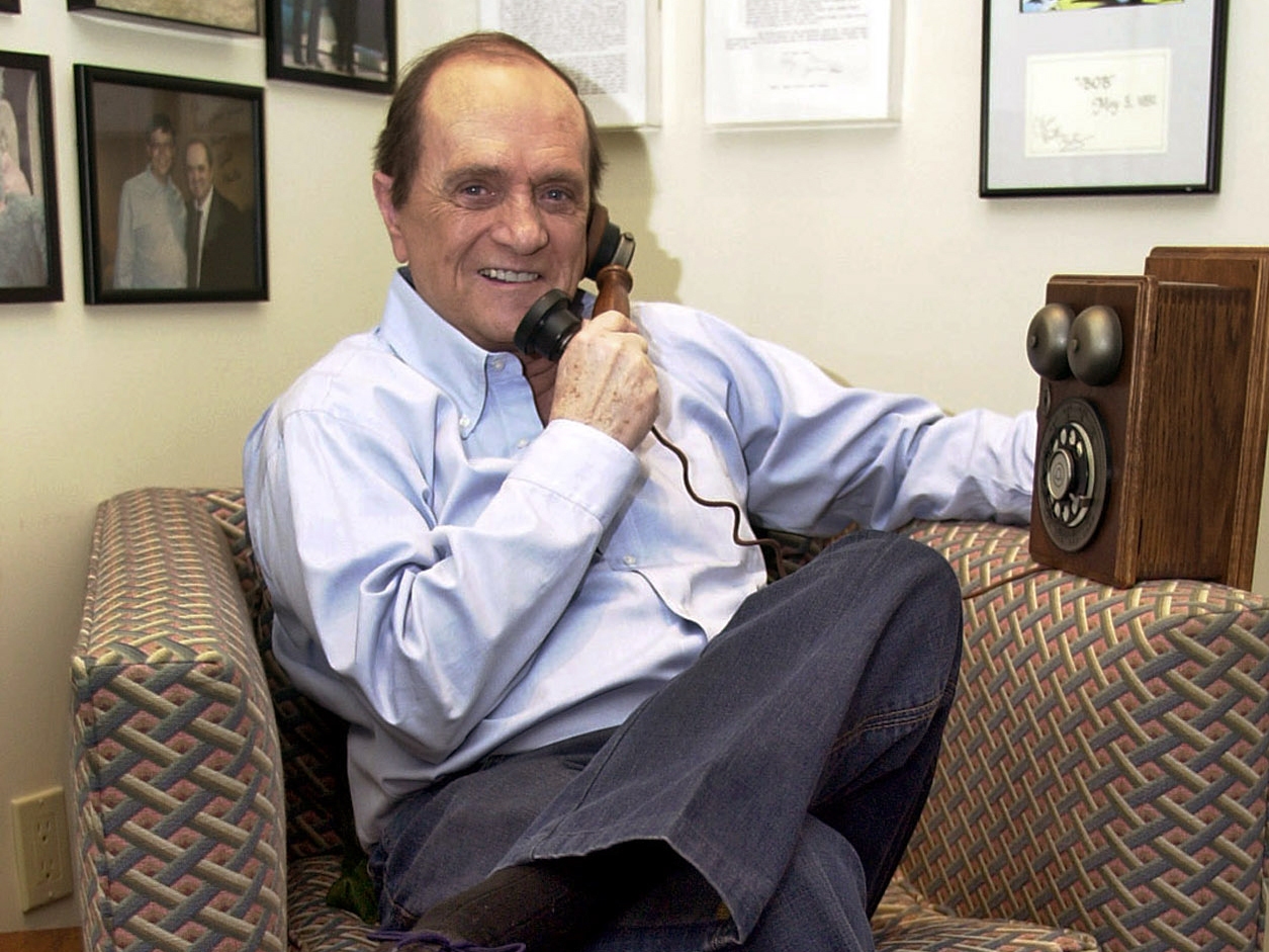 caption: Comedian Bob Newhart pretends to speak on an antique telephone at his home in the Bel Air Estates community of Los Angeles, June 25, 2003. 