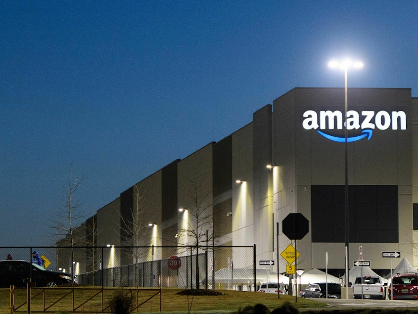 caption: The Amazon.com, Inc. BHM1 fulfillment center is seen before sunrise on March 29, 2021 in Bessemer, Alabama. Amazon announced it is ending its charity donation program, AmazonSmile.