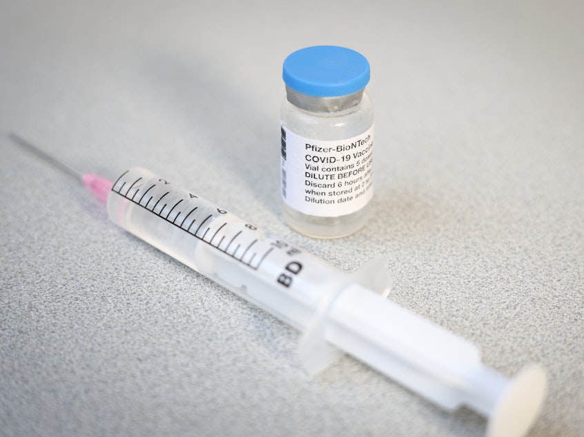 caption: A Pfizer vaccine vial and syringe. A CDC advisory panel has recommended the Pfizer/BioNTech vaccine be administered to adolescents age 12 to 15.