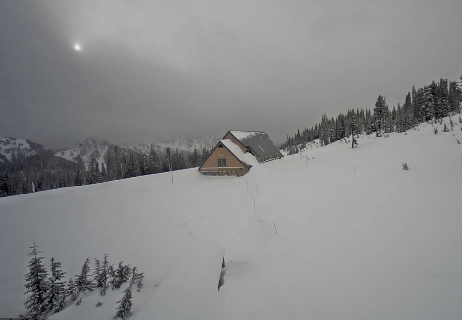 caption: Deep snow surrounds the closed Jackson Visitor Center at Paradise in Mount Rainier National Park in this webcam view Sunday.