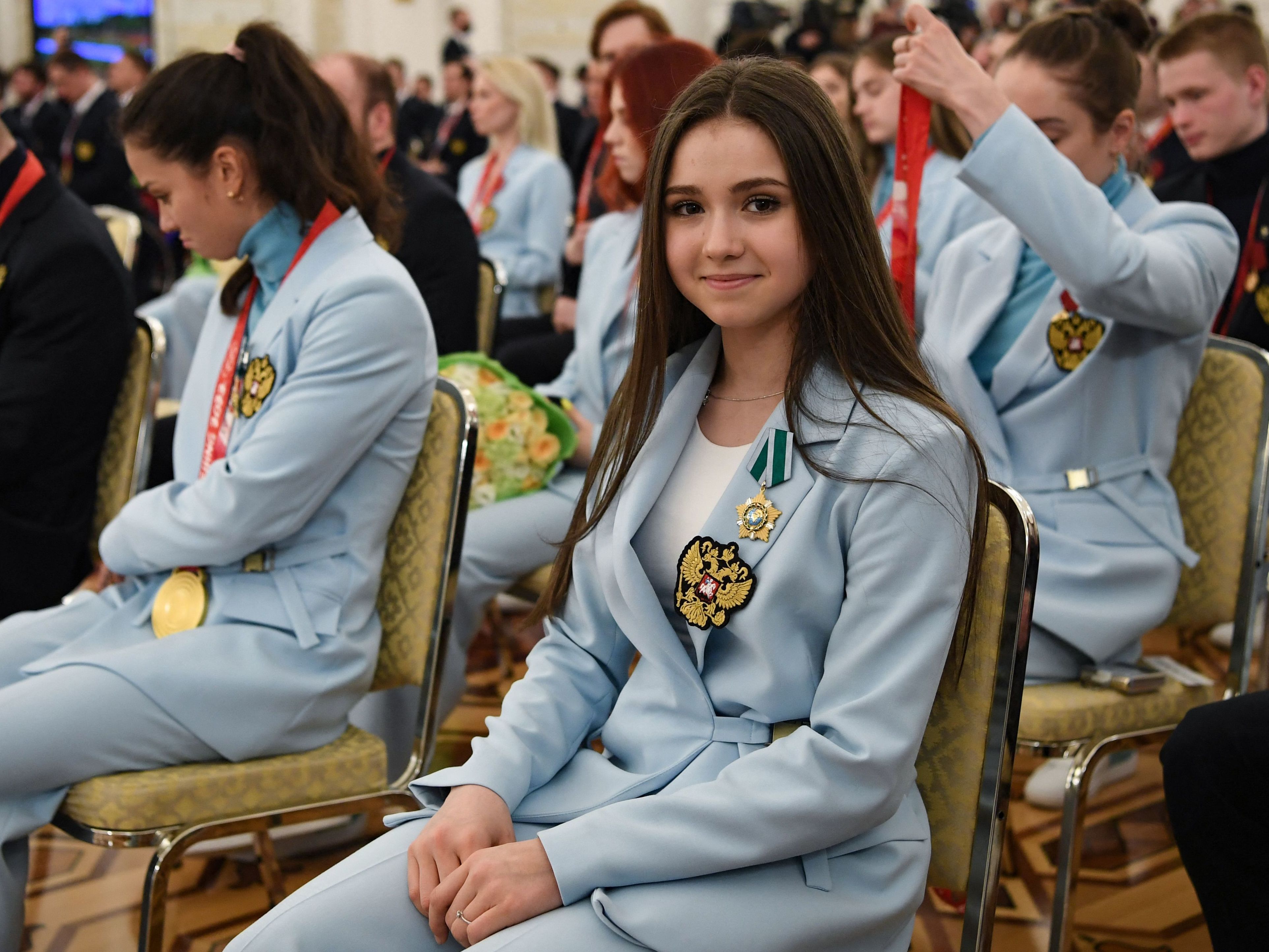 caption: Russian figure skater Kamila Valieva attends a meeting of Russian President Vladimir Putin with Russia's medal-winning athletes of the Beijing 2022 Winter Olympic Games and members of the country's Paralympic team at the Kremlin in Moscow, on April 26 — Valieva's birthday.