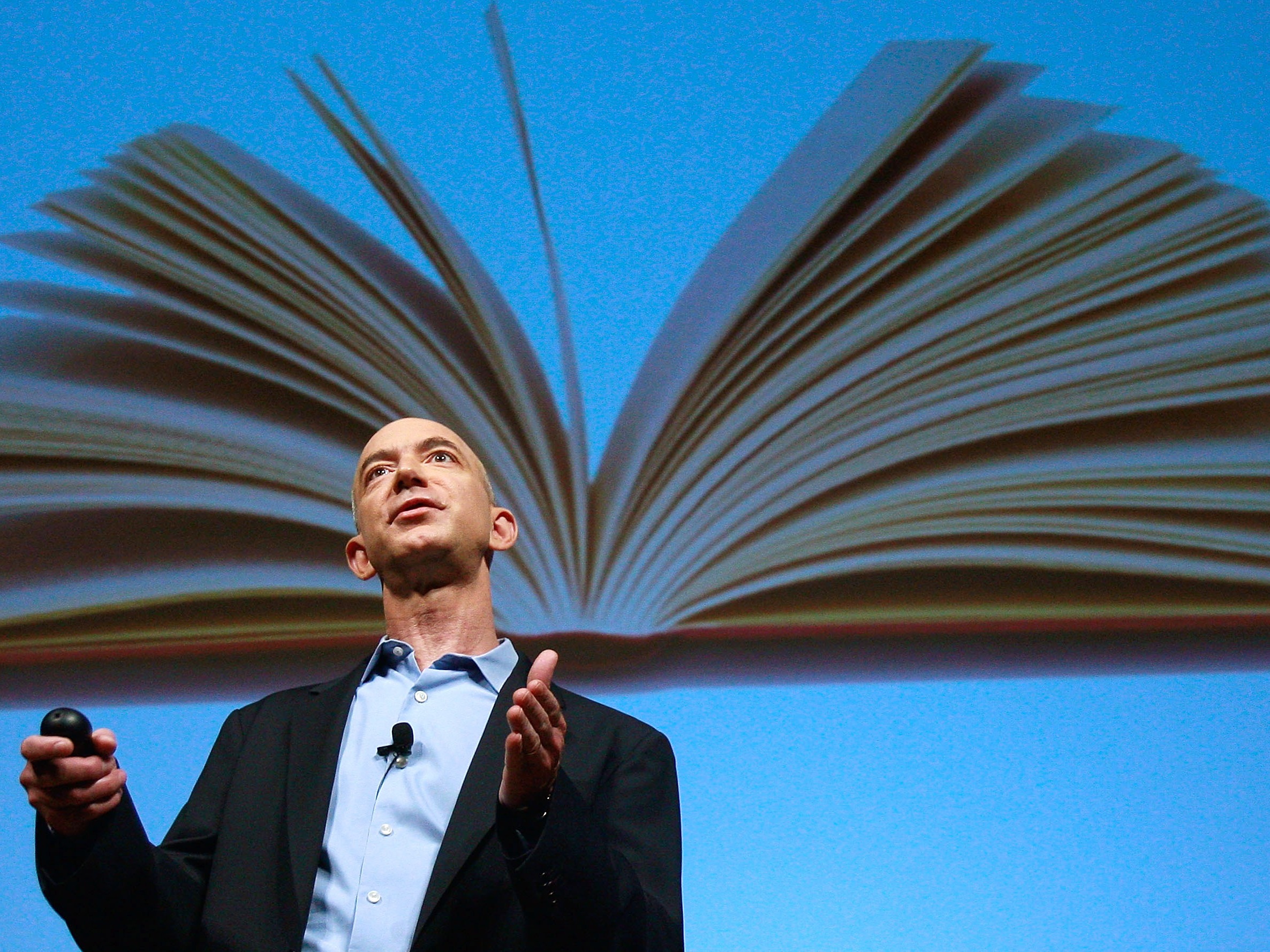 caption: Amazon founder Jeff Bezos speaks at an event unveiling the Kindle 2.0 in 2009. Bezos founded the company in his Bellevue, Wash. garage 30 years ago on July 5, 1995.