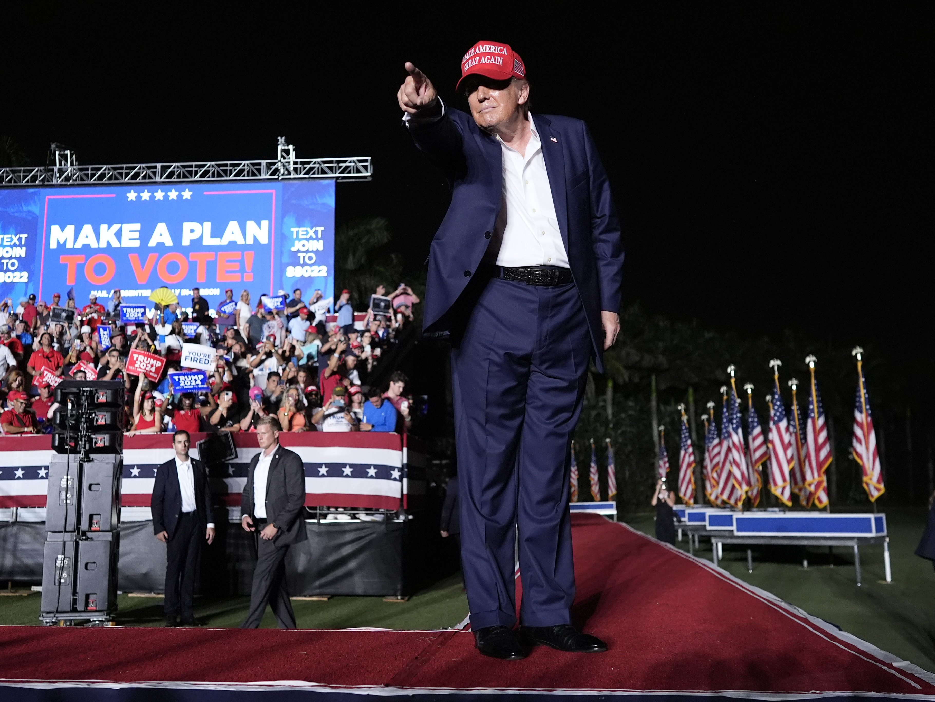 caption: Republican presidential candidate former President Donald Trump gestures after speaking at a campaign rally at Trump National Doral Miami on Tuesday.