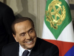 caption: Silvio Berlusconi meets journalists at the Quirinale presidential palace in Rome in 2018.
