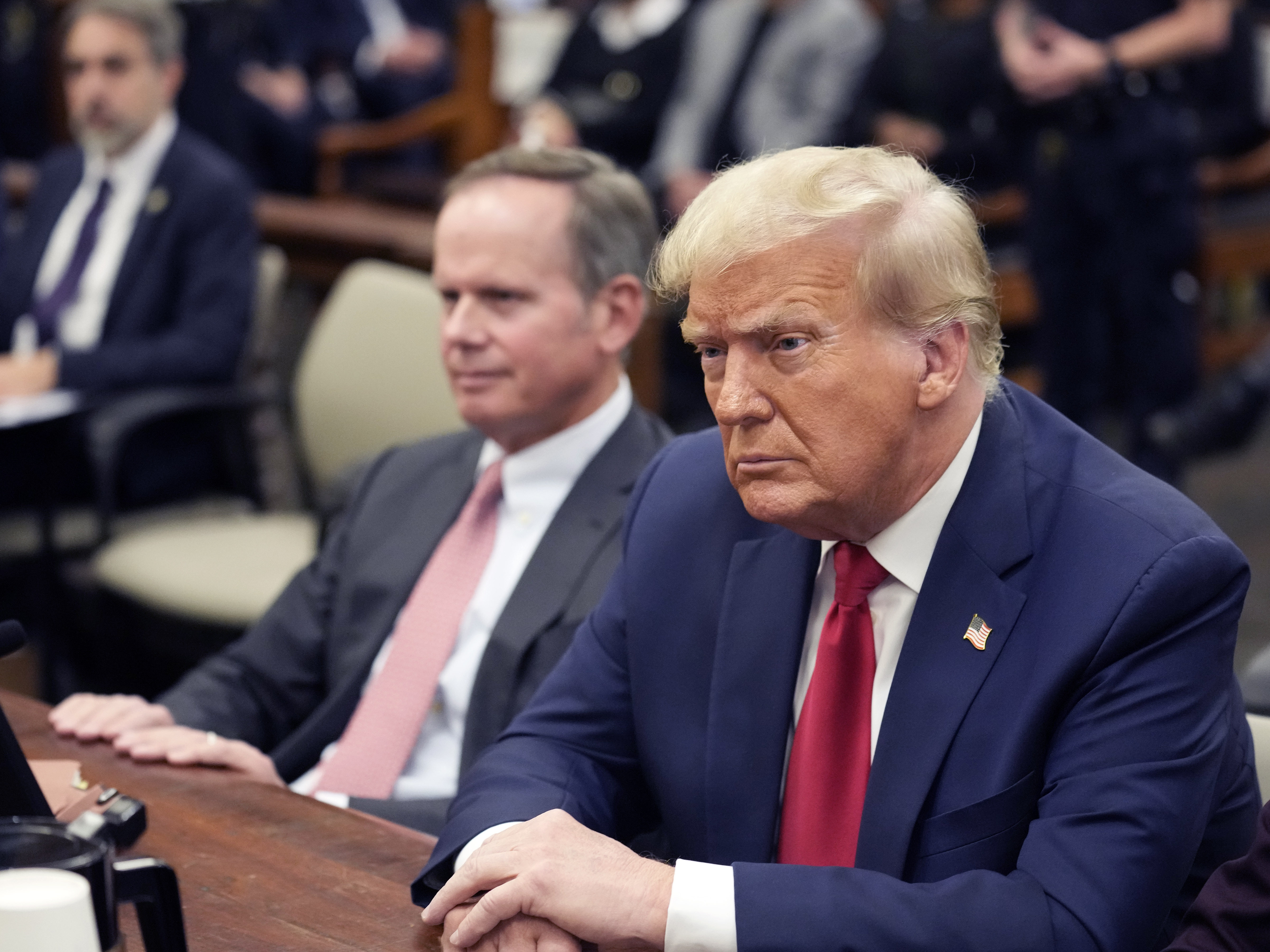 caption: Former President Donald Trump sits in the courtroom with his legal team before the continuation of his civil business fraud trial at New York Supreme Court, Tuesday, Oct. 17, 2023, in New York.