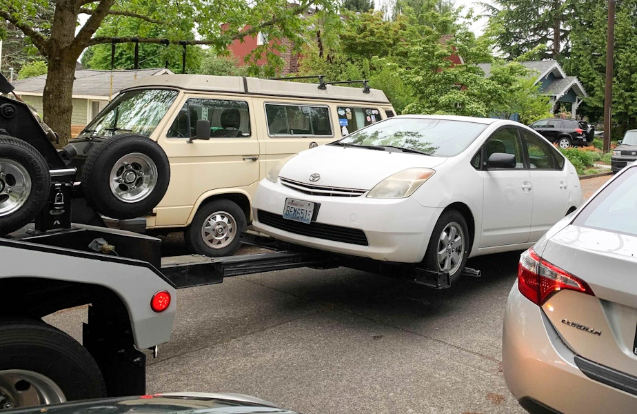 caption: A Prius gets towed in Greenwood on May 17, 2021, after its catalytic converter was stolen from under it the week before. The tow truck driver said he tows three or four cars a day that have had their catalytic converters stolen. 