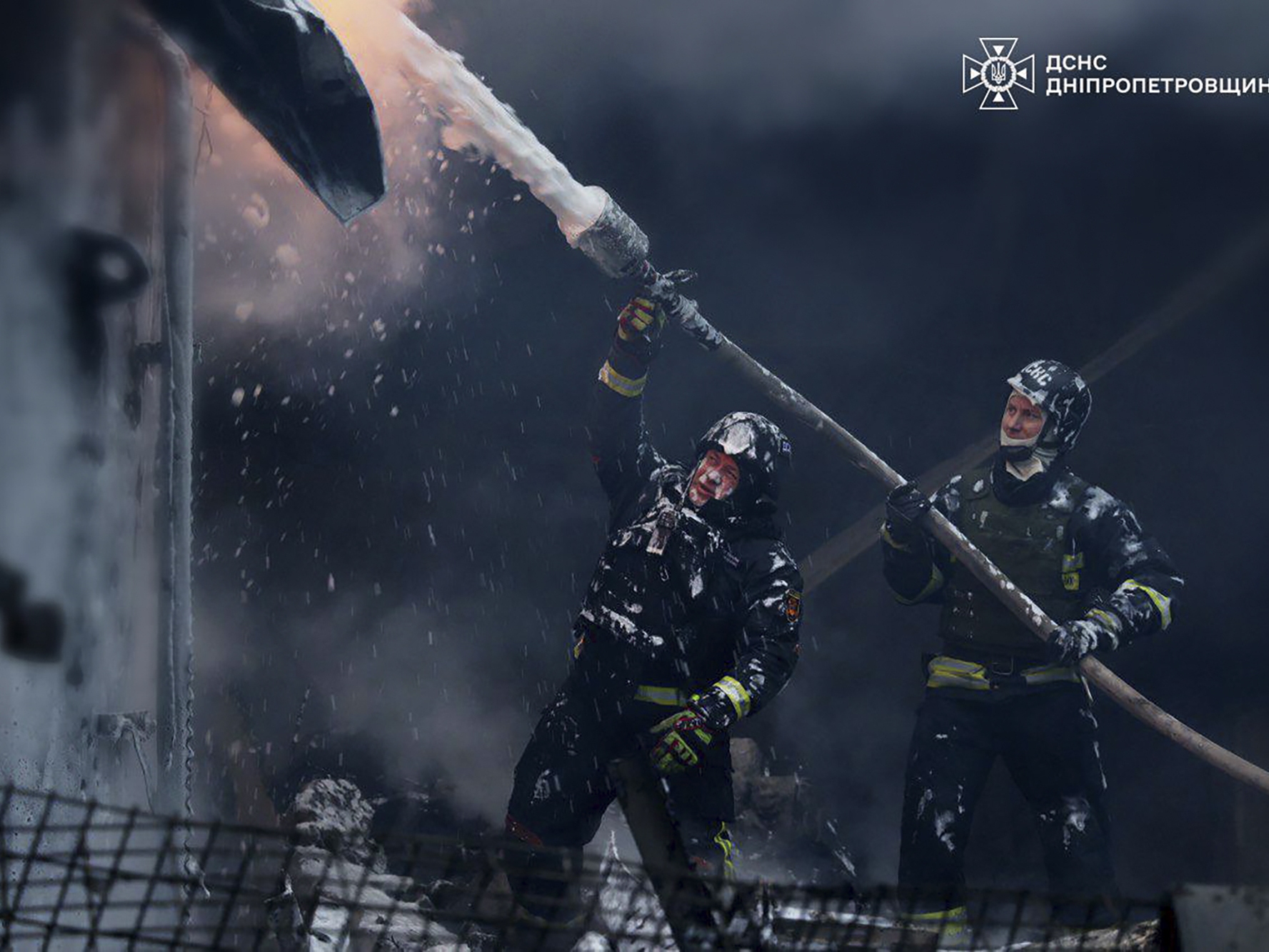 caption: In this image provided by the Ukrainian Emergency Service, firefighters put out a fire following a Russian missile attack on the country's energy system in Dnipropetrovsk region, Ukraine, on Wednesday.