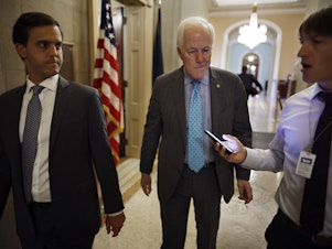 caption: Senate Minority Whip John Cornyn of Texas, the lead Republican negotiator, talks to reporters after giving a speech in support of the Bipartisan Safer Communities Act at the Capitol on Wednesday.