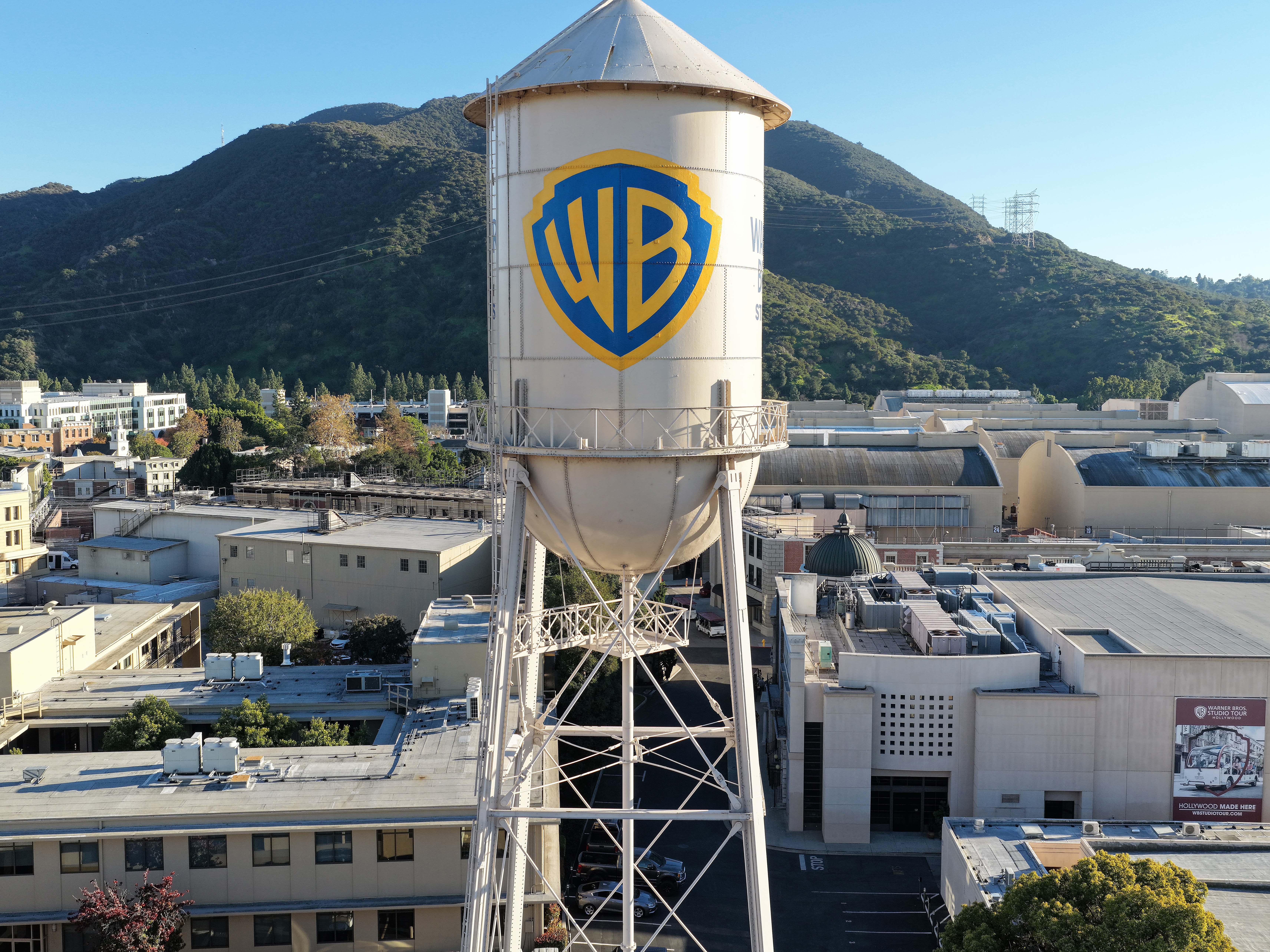 caption: An aerial view of the Warner Bros. logo displayed on the water tower at Warner Bros. Studio on Dec. 5, 2025 in Burbank, Calif.