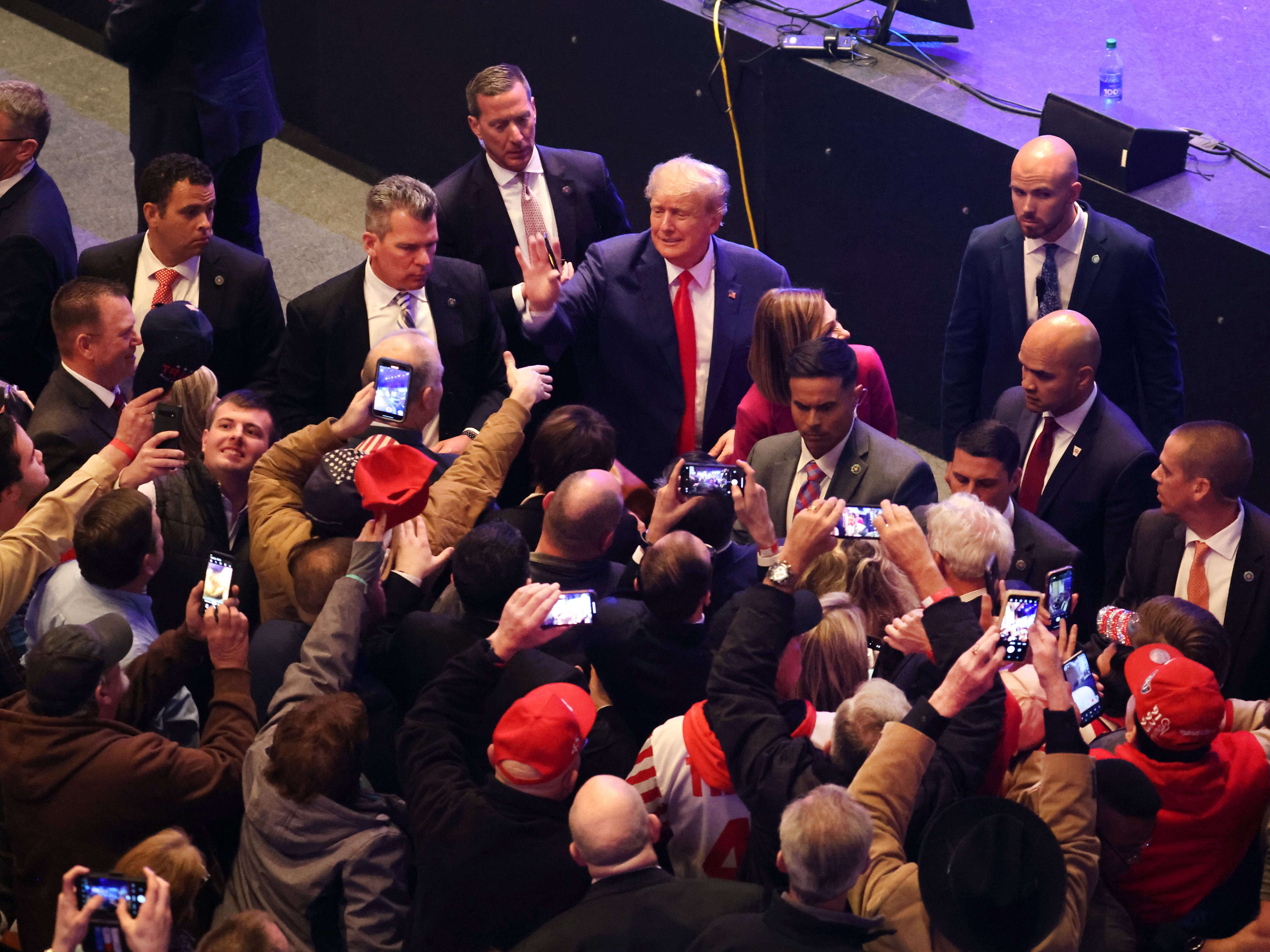 caption: Former President Donald Trump greets guests following an event on March 13, 2023 in Davenport, Iowa. Trump's visit followed those by potential challengers for the GOP presidential nomination, Florida Gov. Ron DeSantis and former U.N. Ambassador Nikki Haley.