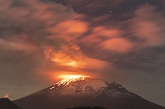 caption: Popocatépetl volcano spews incandescent material on Tuesday. The second highest volcano in the Mexico increased its activity, and authorities raised the alert to the second-highest level.