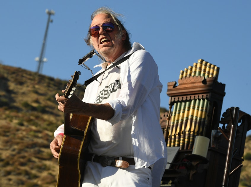 caption: Neil Young, performing in Lake Hughes, Calif. in 2019.