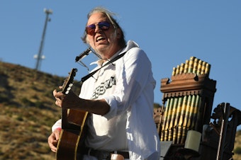 caption: Neil Young, performing in Lake Hughes, Calif. in 2019.