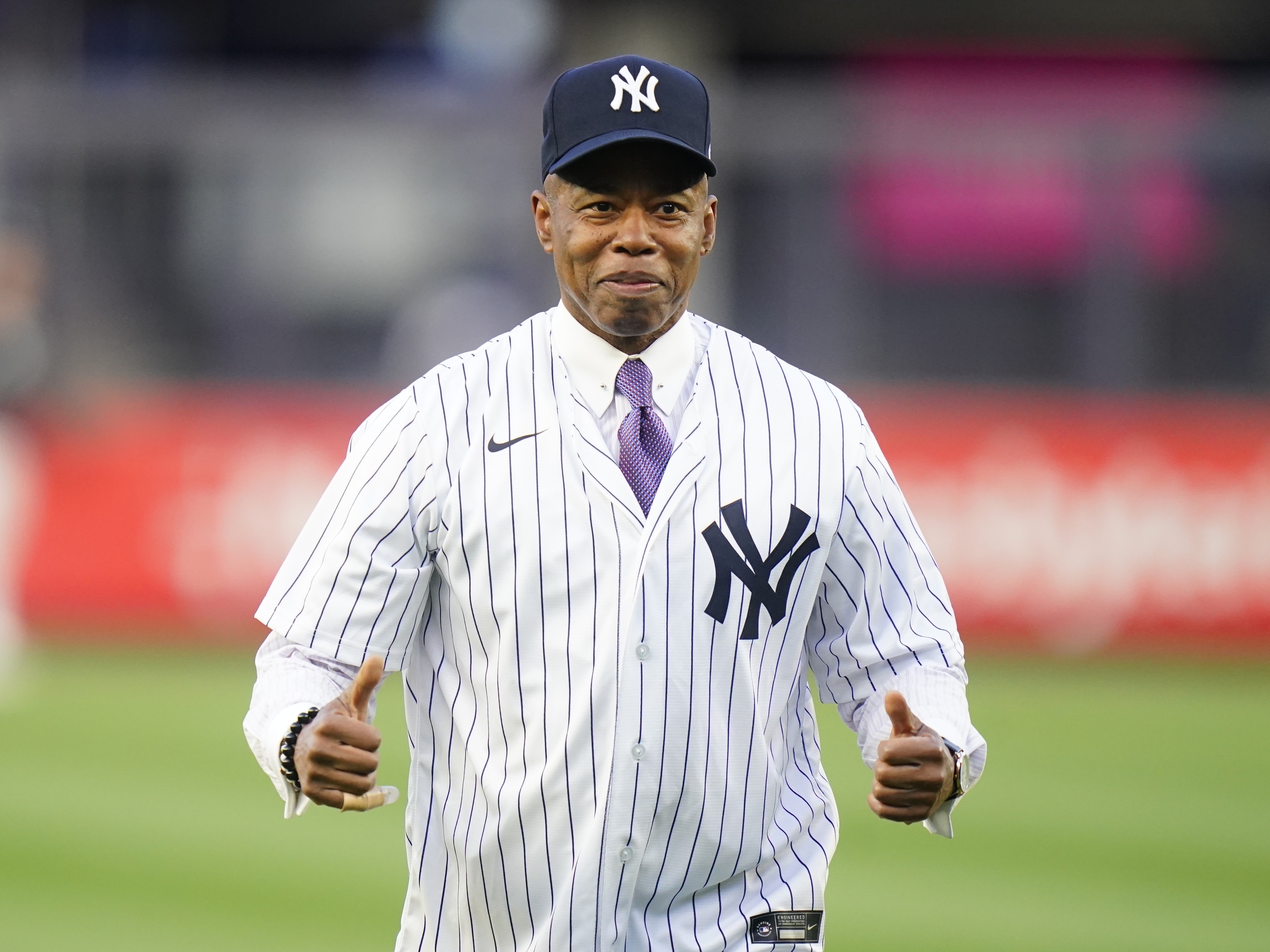 caption: New York City Mayor Eric Adams gestures after throwing out a ceremonial first pitch before a baseball game between the New York Yankees and the Toronto Blue Jays Tuesday, May 10, 2022, in New York.