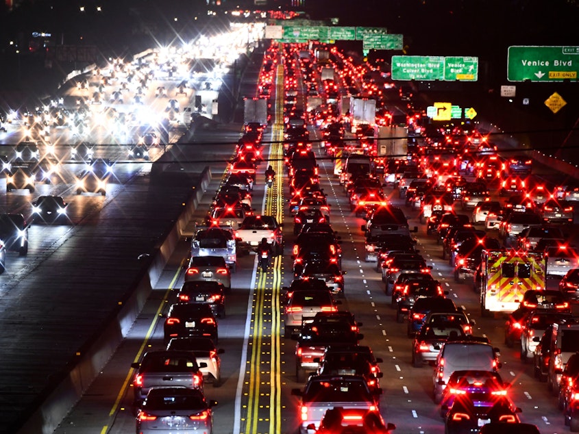 caption: The 405 Freeway during rush hour traffic on March 10, in Los Angeles. Americans' greatest contribution to global greenhouse gas emissions comes from transportation, mostly from cars and trucks, according to the federal government.